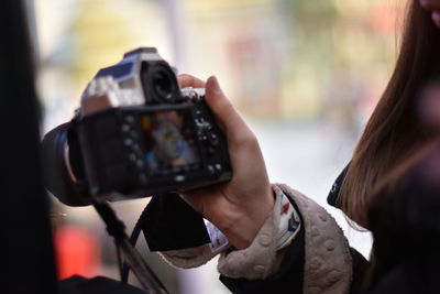 Cropped image of woman photographing