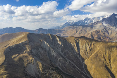 Scenic view of mountains against cloudy sky