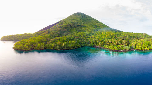 Scenic view of sea and mountains against sky