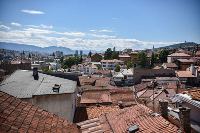 High angle view of houses in town against sky