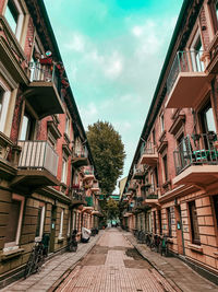 German street amidst buildings against blue sky