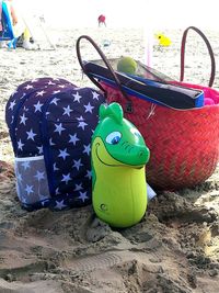 Close-up of toys on beach