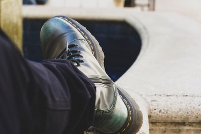 Low section of person sitting outdoors