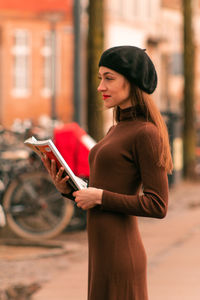 Side view of woman with book