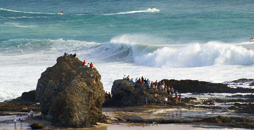 Group of people on rocky shore