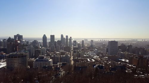 High angle view of modern buildings in city against clear sky