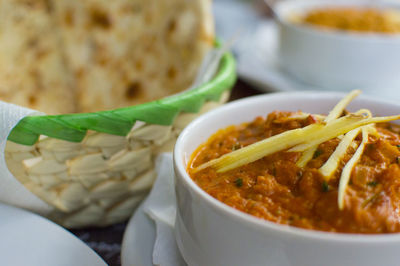 Close-up of vegetable curry and naan on table