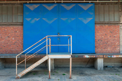 Metallic structure against blue wall