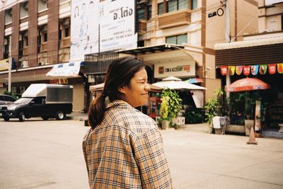 Woman standing on street in city