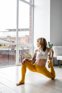 Woman sitting by window at home