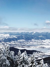 Scenic view of snow covered mountains against sky