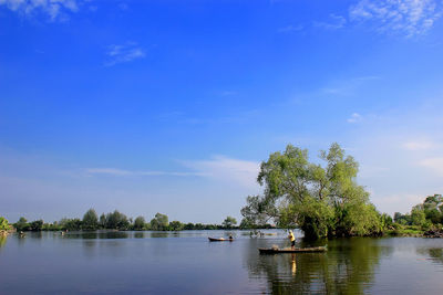 Scenic view of lake against blue sky