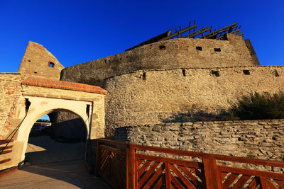 Low angle view of old building against blue sky