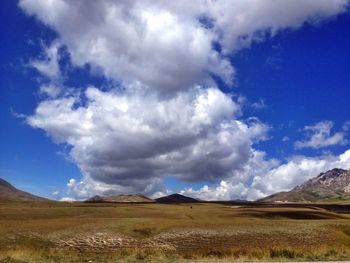 Scenic view of mountains against cloudy sky