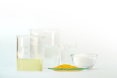 Close-up of cocktail in glass on table against white background