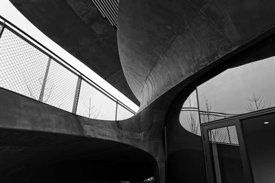 Low angle view of bridge and buildings against sky