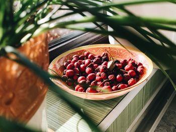 High angle view of berries in plate on window sill