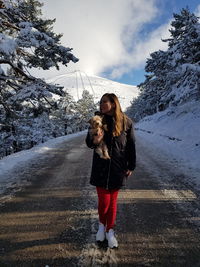 Full length of woman with dog during winter