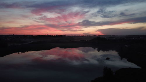 Scenic view of lake against romantic sky at sunset