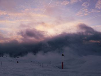 Scenic view of snow covered field against sky