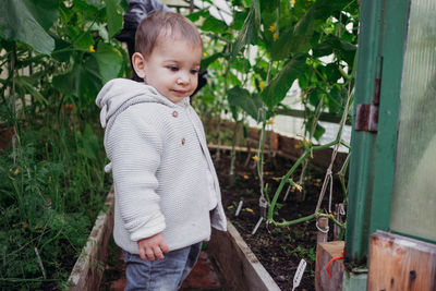 Girl standing in greenhouse