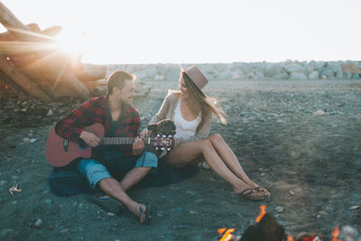 Young couple sitting on swing