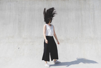 Young woman shaking head while standing on street