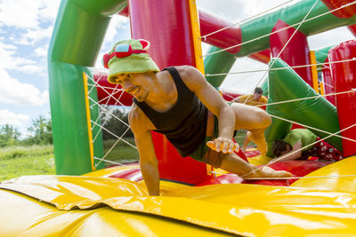 Man playing on colorful bouncy castle