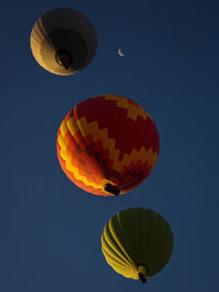 Low angle view of hot air balloon against clear blue sky