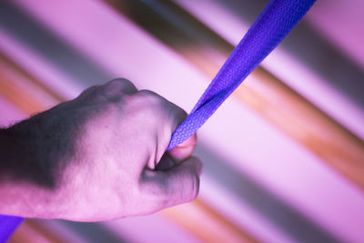 Cropped hand holding strap in gym