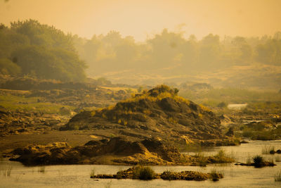 Scenic view of lake against sky during sunset