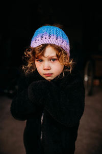 Young girl standing outside crying during winter