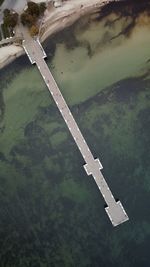 High angle view of airplane flying over road