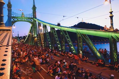 Crowd at music concert against sky in city