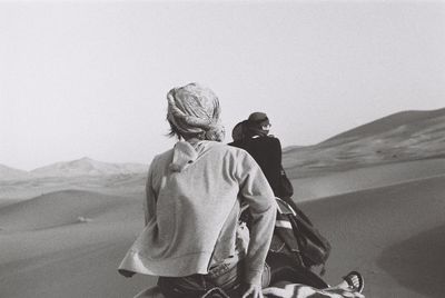 Rear view of couple on road against sky