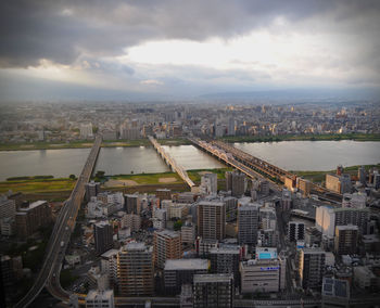 Cityscape against cloudy sky