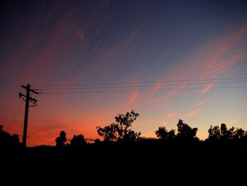 Silhouette trees against sky during sunset