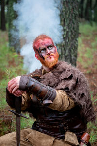 Portrait of man sitting outdoors