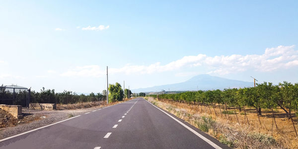 Empty road along countryside landscape