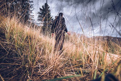 Man standing on field against sky