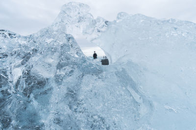Silhouette person seen through iceberg at jokulsarlon glacial lagoon