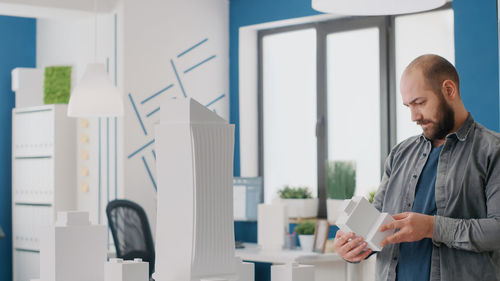 Side view of woman using mobile phone in office