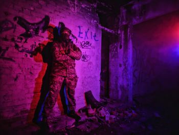 Full length of woman standing in abandoned building