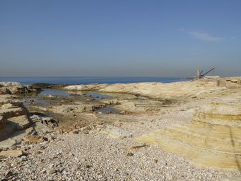 Scenic view of beach against clear sky