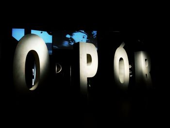 Close-up of illuminated lamp against black background