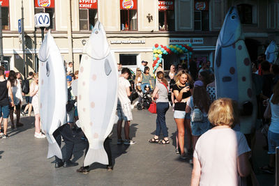 Group of people walking on road in city