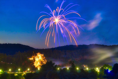 Low angle view of firework display at night