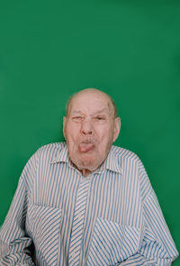 Portrait of man wearing mask against gray background