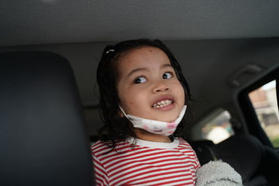 Portrait of cute girl in car