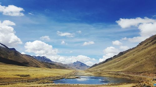 Scenic view of lake and mountains against sky